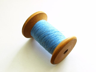 Blue thread on wooden spool