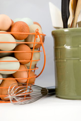 Wire basket of eggs with utensils