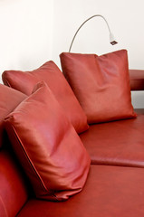 Pillows of a red leather sofa
