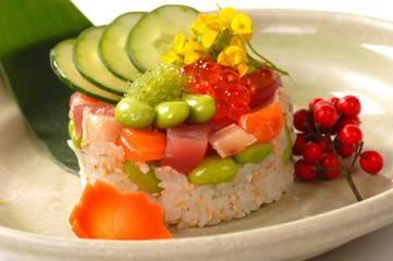 Asian appetizer of rice with tuna, salmon and vegetables
