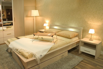 Interior of modern bedroom with furniture and lamps