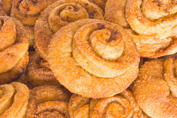 Lots of  fresh rolls with cinnamon and sugar