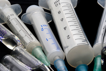 Some syringes on black background