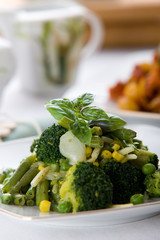 Fresh green vegetable salad with corn and basil