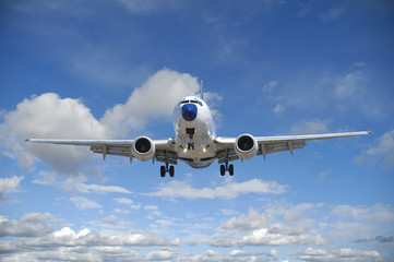 Air travel - Plane is flying in blue sky with clouds