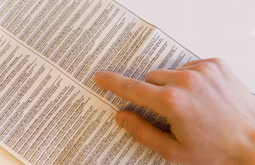 Male hand over newspaper on white background