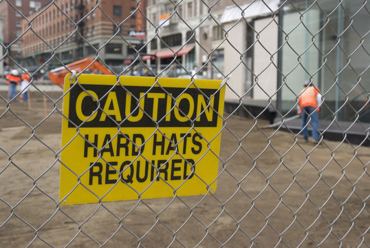 Caution, Hard Hats Required sign at a construction site.