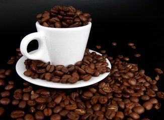 A coffee mug full of coffee beans