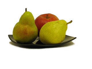 Pears and apple on black dish