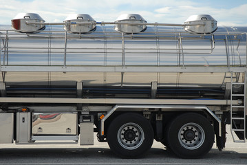 Cargo on a shiny steel semi trailer. Boggy wheels. Copy space.