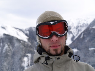 The snowy face of a snowboarder guy.