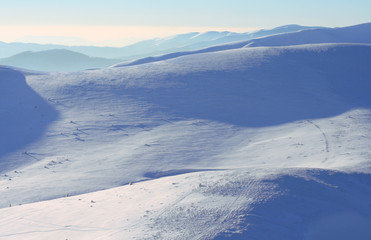 Winter mountains under the snow and bright sunlight.