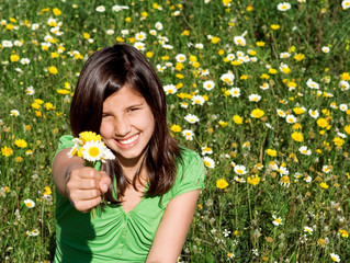happy smiling kid giving gift of flowers