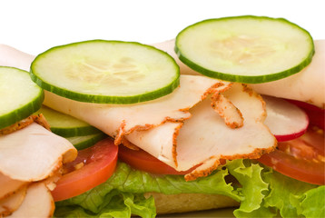 Close up of roasted turkey sandwich on white background