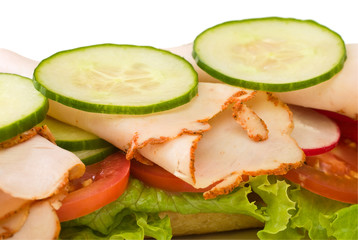 Fototapeta na wymiar Close up of roasted turkey sandwich on white background