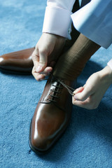 Man putting on shoes for work