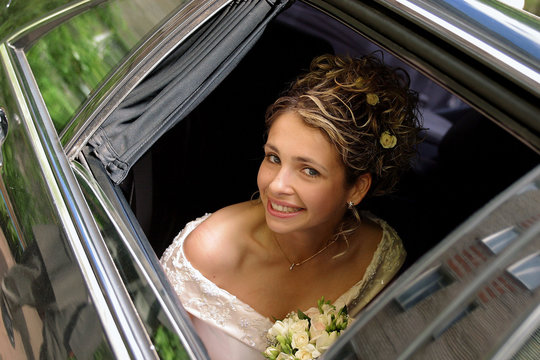 Bride In White Wedding Dress In Wedding Limo