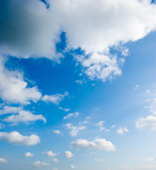 cloudscape of fluffy clouds in the blue sky