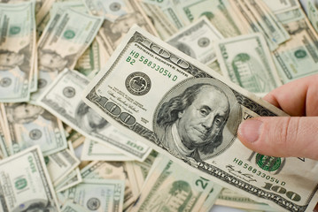 hand holding 100 bill