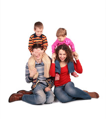 parents sit with children on shoulders