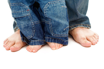 father's and son's feet in jeans