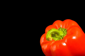 Single red Bell Pepper on a black background