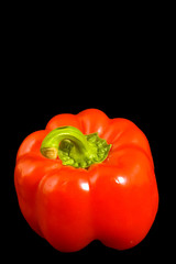 Single red Bell Pepper on a black background