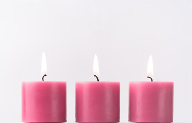 Obraz na płótnie Canvas Three pink candles