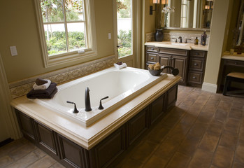Designer bathroom with a modern tub and tile floor.