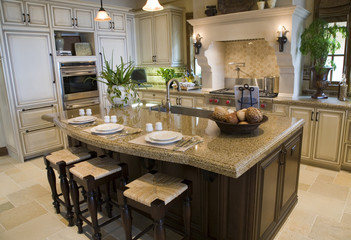 Luxury home kitchen with a granite island.