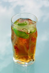 Glass of ice tea on blue background
