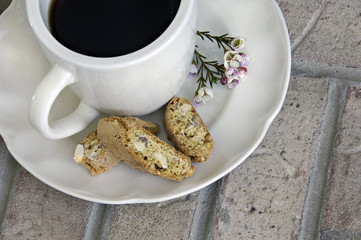 Cup of Coffee with Biscotti and Flowers