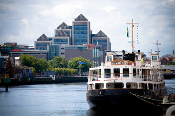 Ferryboat Docked in port with modern buildings in the background