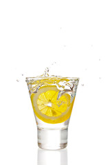 Fototapeta na wymiar Lemon splashing into martini glass