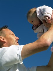 Fototapeta premium .Father hold baby up in the air