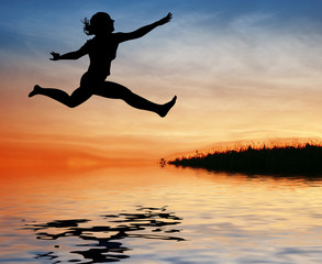 Fototapeta na wymiar silhouette jump girl on water