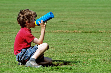 boy at park having a drink