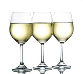 three wine glasses filled with white wine side by side