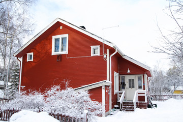 Red wooden Finnish house in winter - Powered by Adobe