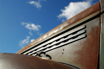 vintage pick-up truck against blue cloudy sky