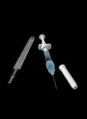 medical thermometer and syringe isolated on black background