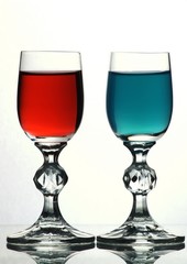 Two glasses with red and blue liquid