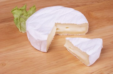Fototapeta na wymiar French cheese with salad on wooden backround 