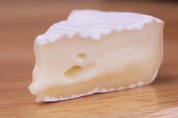 Piece of french cheese on wooden backround