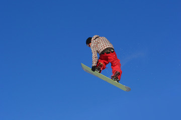 Snowboarder performing "lien air" grab