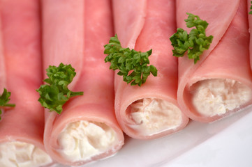 Rolled ham filled by cream with horseradish
