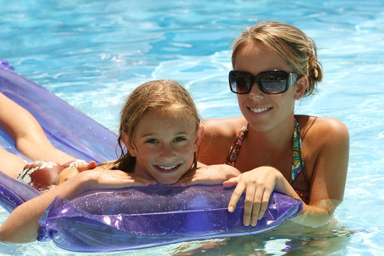 woman and little girl in a swimming pool