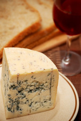 Fresh blue cheese with bread and red wine on the table