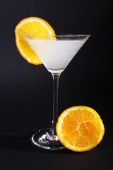 Martini glass with cider and orange slices