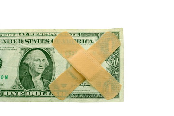 US dollar bill with bandaids